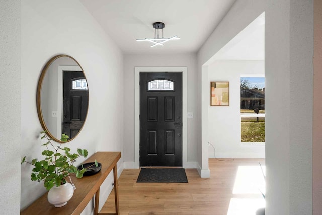 entrance foyer with light wood-style flooring and baseboards