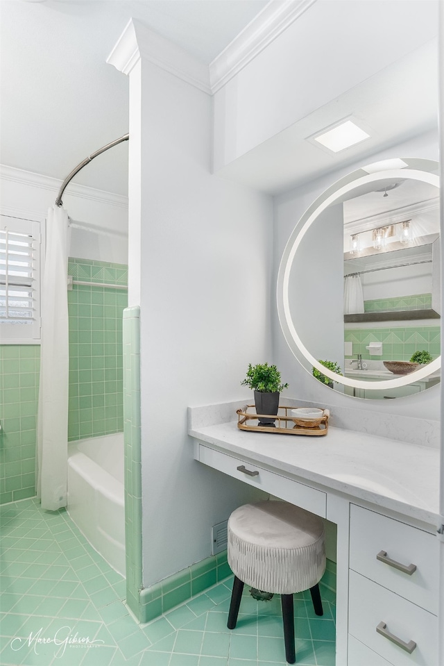 bathroom featuring tile patterned floors, vanity, shower / bath combo with shower curtain, and ornamental molding