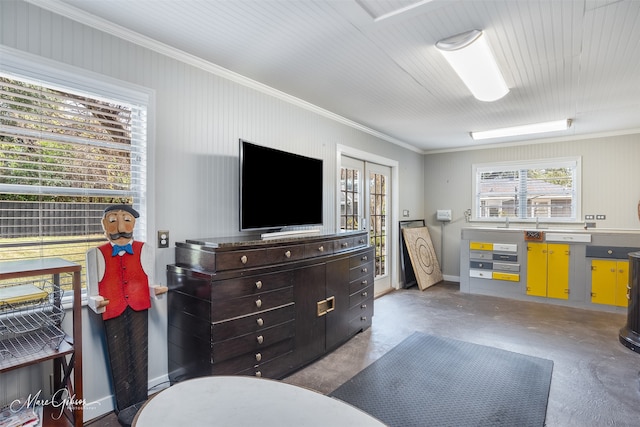 interior space featuring concrete flooring and ornamental molding