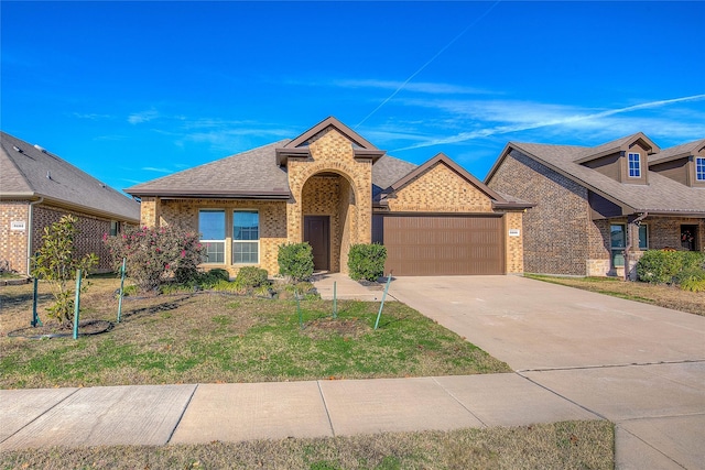 view of front of house with a garage and a front yard