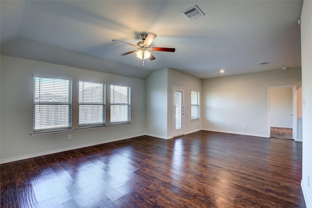 empty room with ceiling fan, lofted ceiling, and dark wood-type flooring