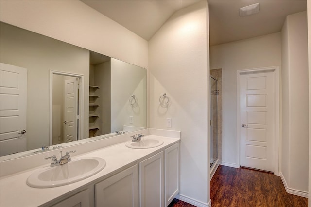 bathroom with lofted ceiling, vanity, wood-type flooring, and an enclosed shower