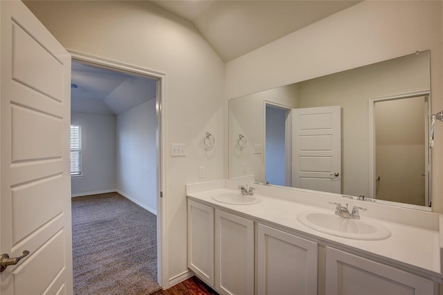 bathroom with vanity and lofted ceiling