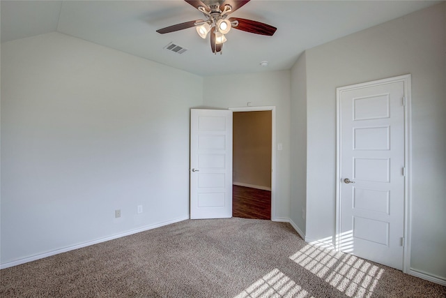 unfurnished bedroom with ceiling fan, carpet, and lofted ceiling