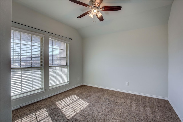 carpeted spare room with ceiling fan and lofted ceiling