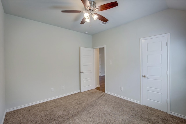 carpeted empty room with ceiling fan and vaulted ceiling