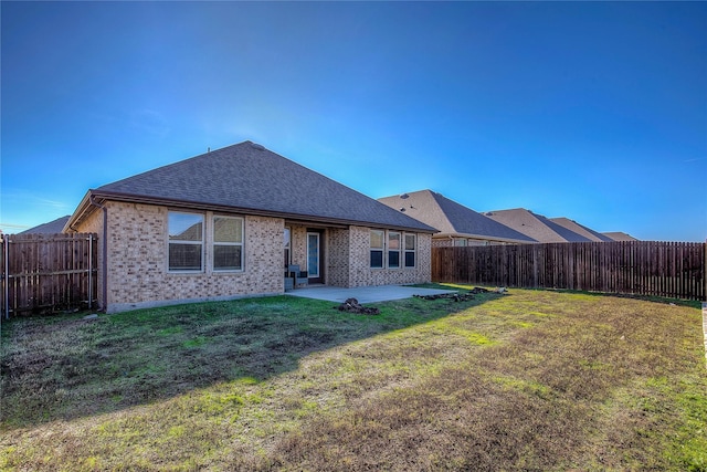 back of house featuring a patio area and a yard