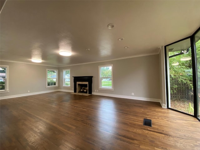 unfurnished living room featuring ornamental molding and dark wood-type flooring