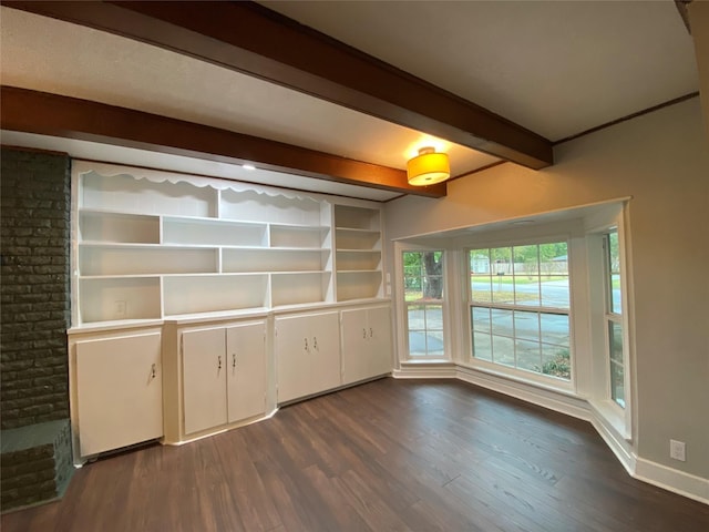 kitchen featuring beamed ceiling, dark hardwood / wood-style flooring, and white cabinetry