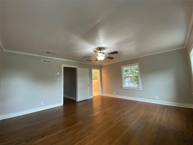 empty room with ceiling fan, dark hardwood / wood-style flooring, and ornamental molding