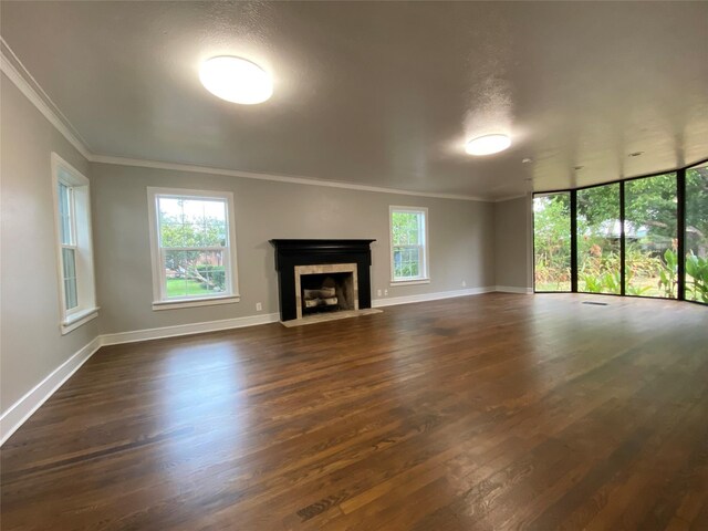 unfurnished living room featuring a textured ceiling, dark hardwood / wood-style flooring, and crown molding