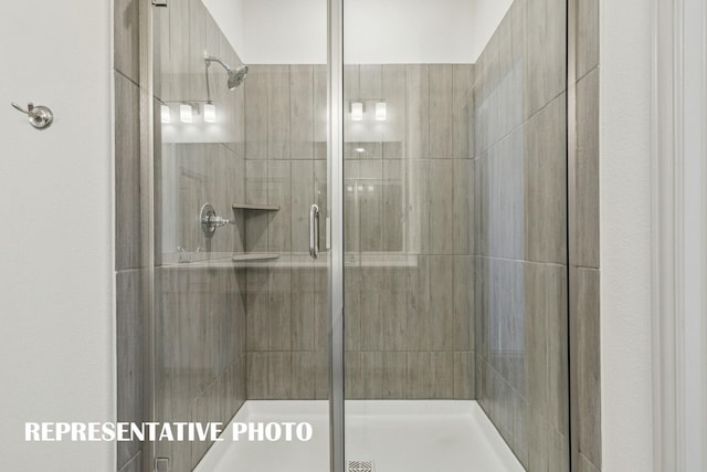 bathroom featuring a shower with door