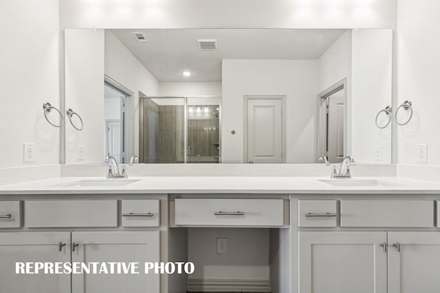 bathroom featuring vanity and a shower with shower door