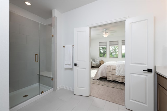 bathroom with ceiling fan, tile patterned flooring, vanity, and walk in shower