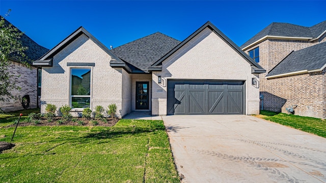 view of front of house with a garage and a front yard