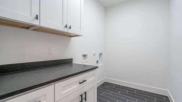 clothes washing area featuring hookup for an electric dryer, cabinets, and hookup for a washing machine