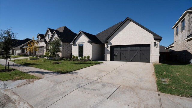 view of front of property featuring a front yard and a garage