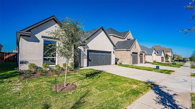 view of front of property with a garage and a front lawn