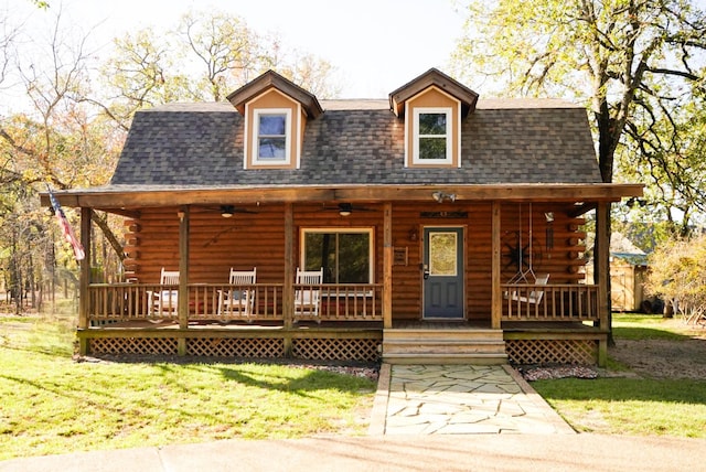 cabin with a front yard and a porch