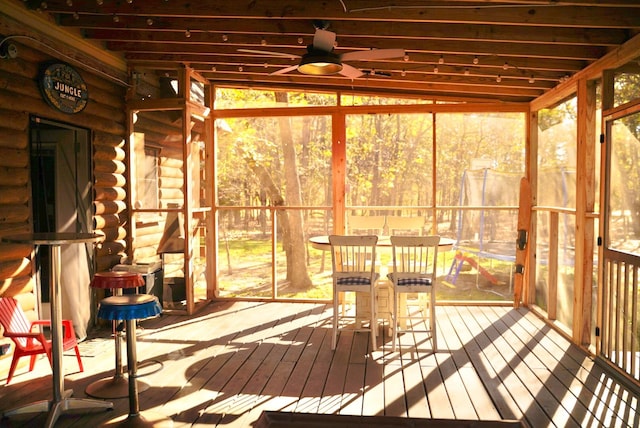 unfurnished sunroom with ceiling fan and lofted ceiling