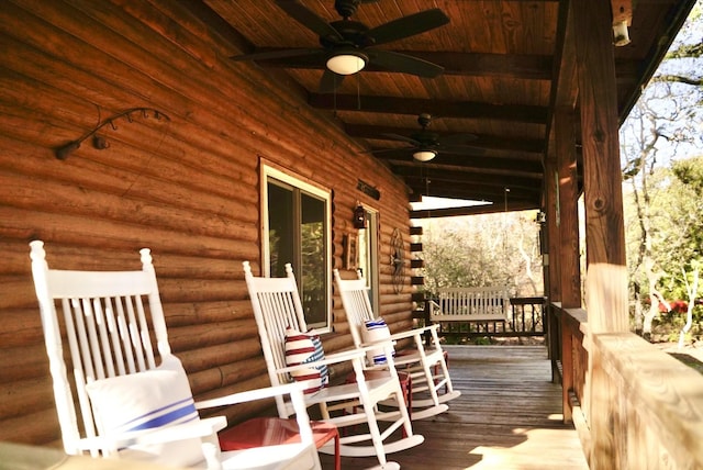 wooden deck featuring covered porch and ceiling fan