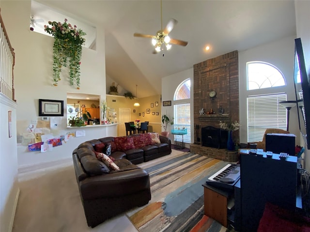 carpeted living room featuring ceiling fan, high vaulted ceiling, and a brick fireplace