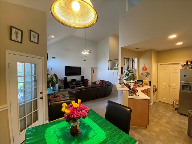 dining room featuring ceiling fan and high vaulted ceiling