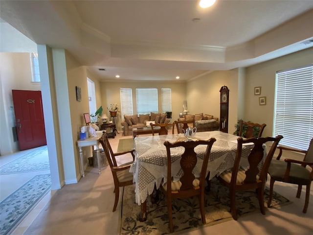 dining room featuring crown molding, a wealth of natural light, and a tray ceiling