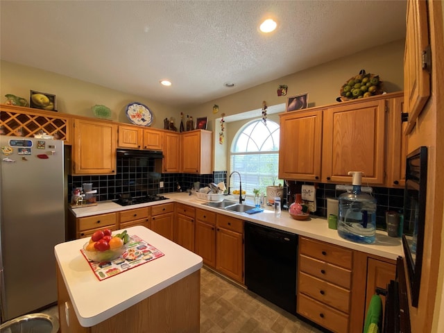 kitchen with a center island, black appliances, sink, decorative backsplash, and a textured ceiling