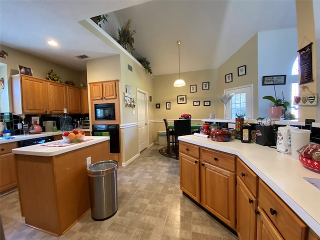 kitchen featuring a center island, black appliances, and decorative light fixtures