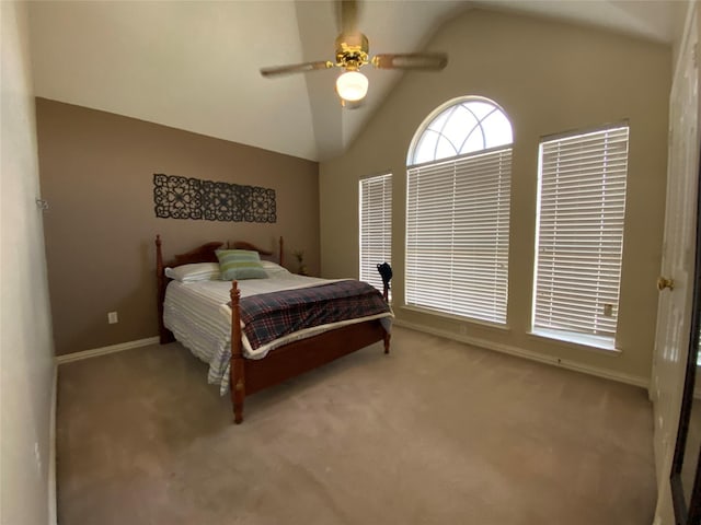 carpeted bedroom with ceiling fan and vaulted ceiling