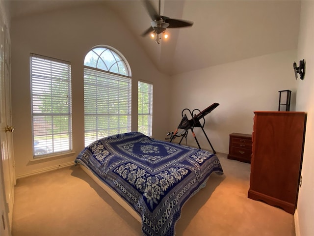 bedroom with ceiling fan, carpet floors, multiple windows, and vaulted ceiling