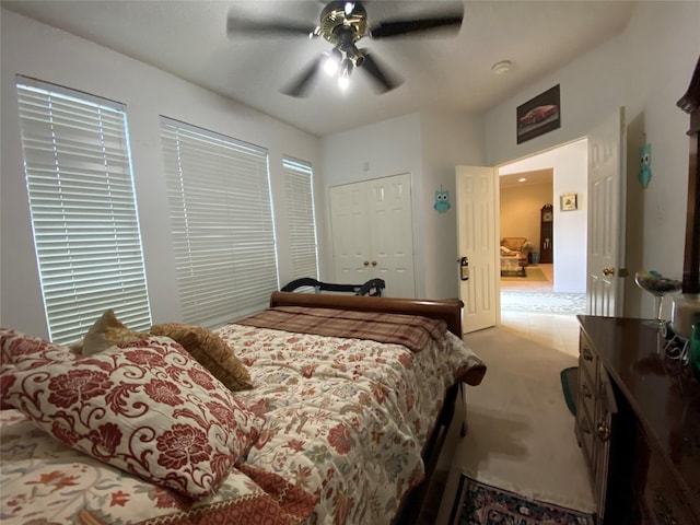 carpeted bedroom featuring a closet and ceiling fan