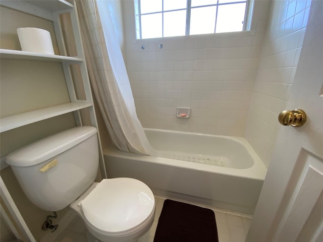 bathroom with shower / bath combination with curtain and toilet