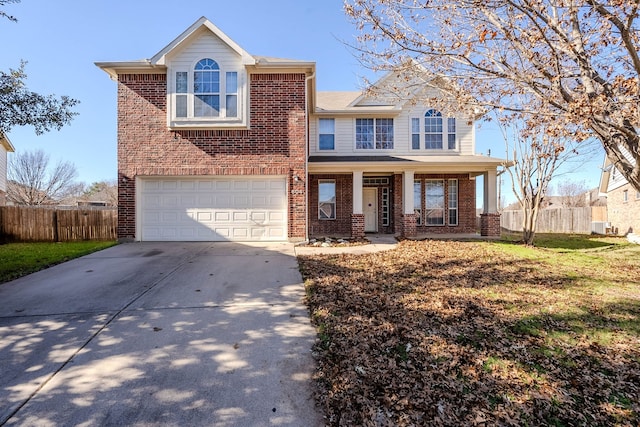 view of front of home featuring covered porch, a garage, and a front lawn