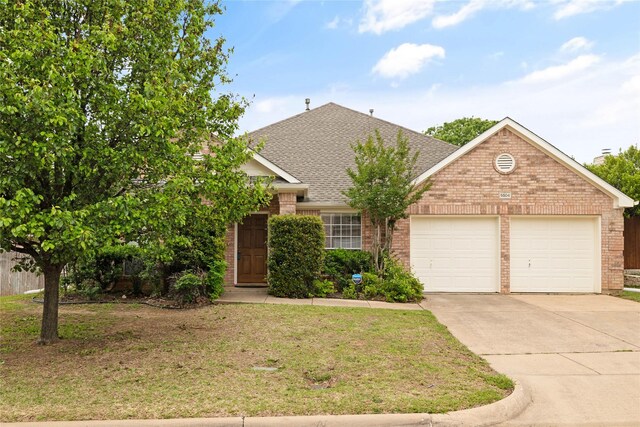 view of front of home with a front lawn and a garage