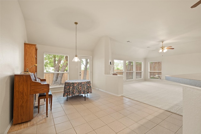 interior space featuring light tile patterned floors, ceiling fan, and lofted ceiling