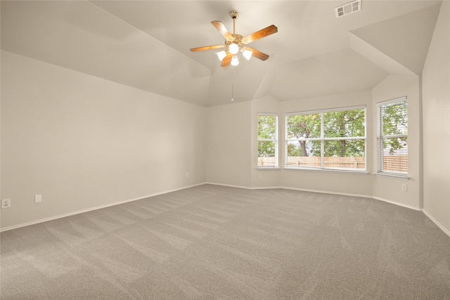 empty room with ceiling fan, carpet floors, and lofted ceiling