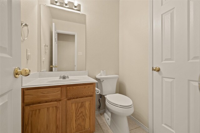 bathroom featuring tile patterned floors, vanity, and toilet