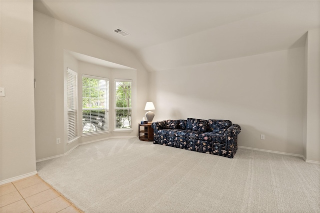 sitting room featuring light colored carpet and lofted ceiling