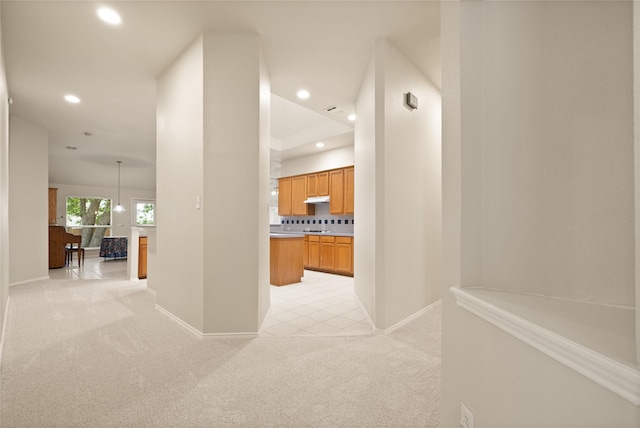 hallway featuring light colored carpet