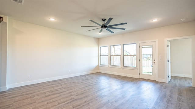 spare room with light hardwood / wood-style flooring and ceiling fan