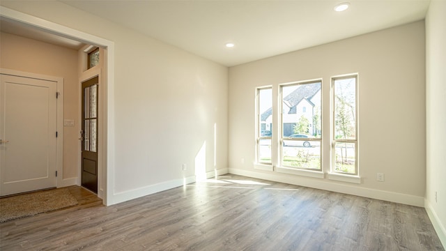 empty room featuring hardwood / wood-style flooring and plenty of natural light