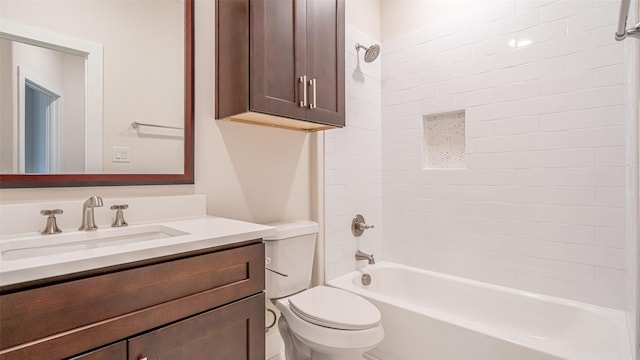 full bathroom featuring vanity, tiled shower / bath combo, and toilet