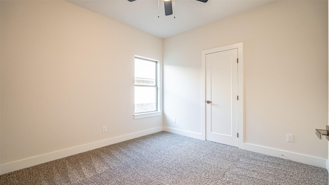 spare room featuring ceiling fan and carpet flooring