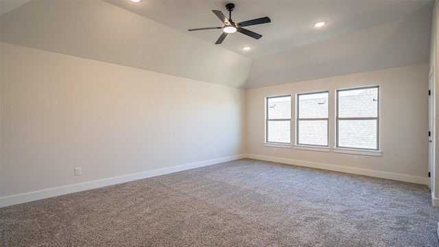 spare room featuring lofted ceiling, carpet floors, and ceiling fan