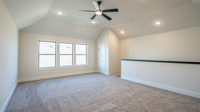 carpeted empty room featuring lofted ceiling and ceiling fan