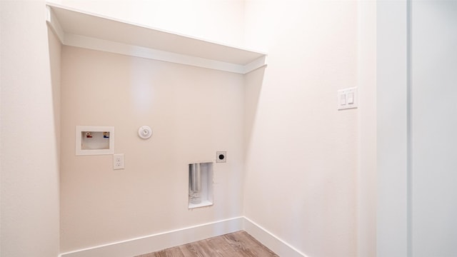 laundry area featuring hookup for a gas dryer, hookup for a washing machine, light hardwood / wood-style flooring, and electric dryer hookup