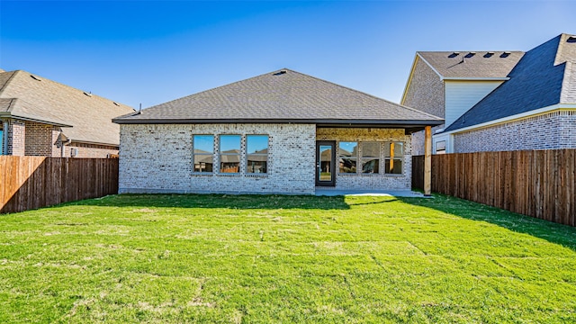 rear view of house with a patio and a lawn