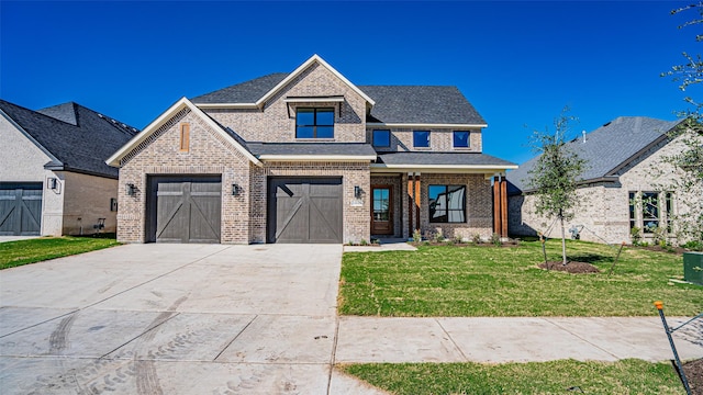 view of front of home with a front yard and a garage